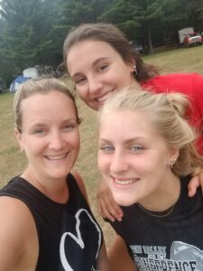 a mom and her two daughters smiling