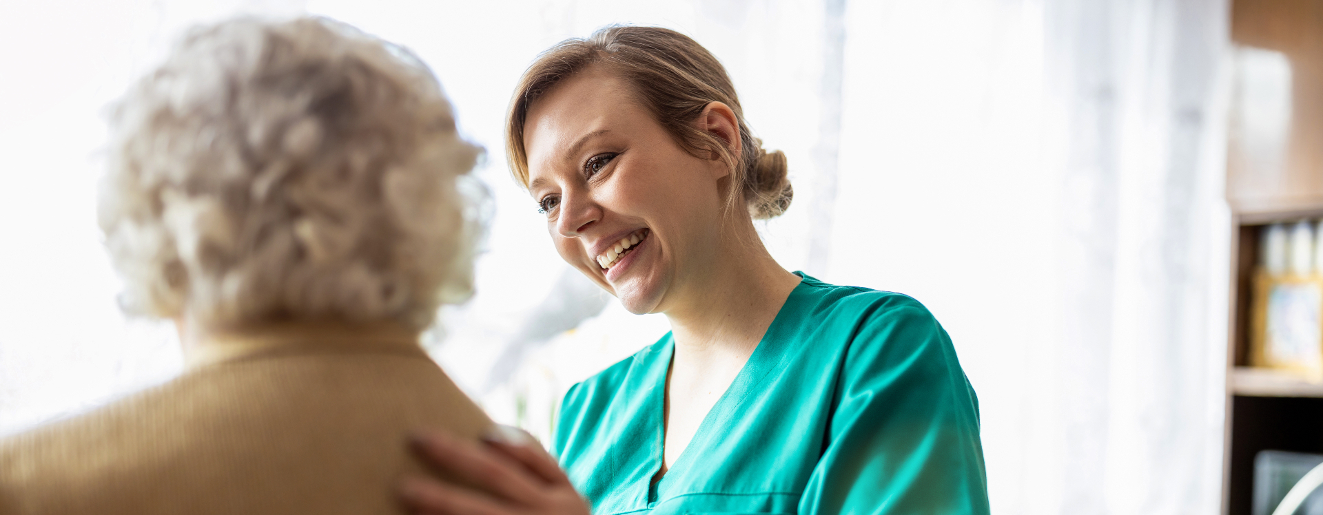 Friendly nurse supporting an elderly woman for healthcare career