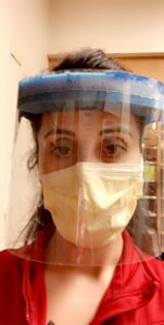 Travel nurse, Erica Wildes, wears a face mask and face shield while workin during her shift.
