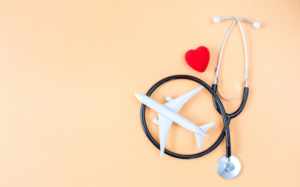Stethoscope and toy plane on a bright orange background