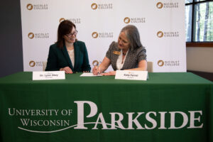 Dr. Lynn Akey, Chancellor of UW-Parkside, and Kate Ferrel, President of Nicolet College, pictured signing transfer agreements. 