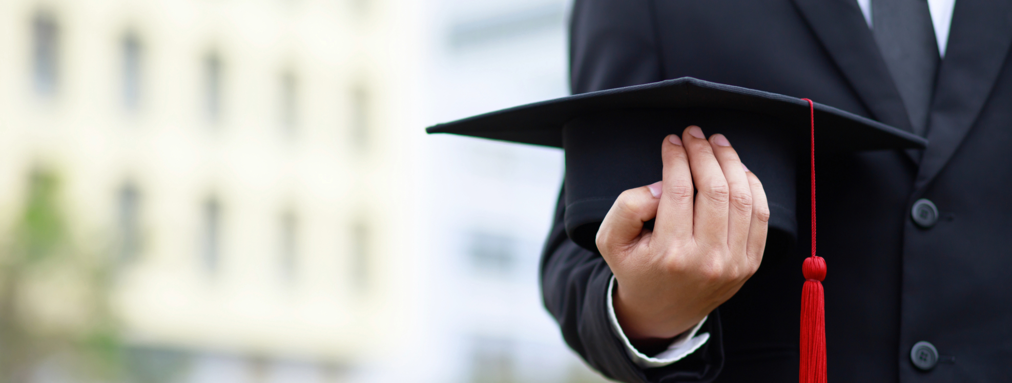 photo of a graduate holding a cap