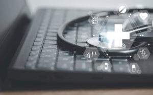 Stethoscope on a laptop with medical images