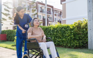 nurse helping patient in a wheelchair