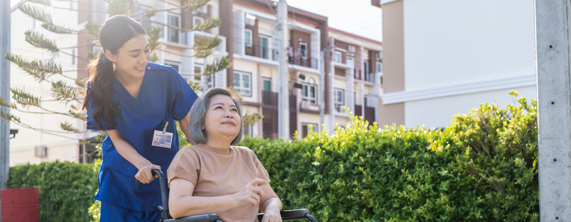 nurse helping patient in a wheelchair