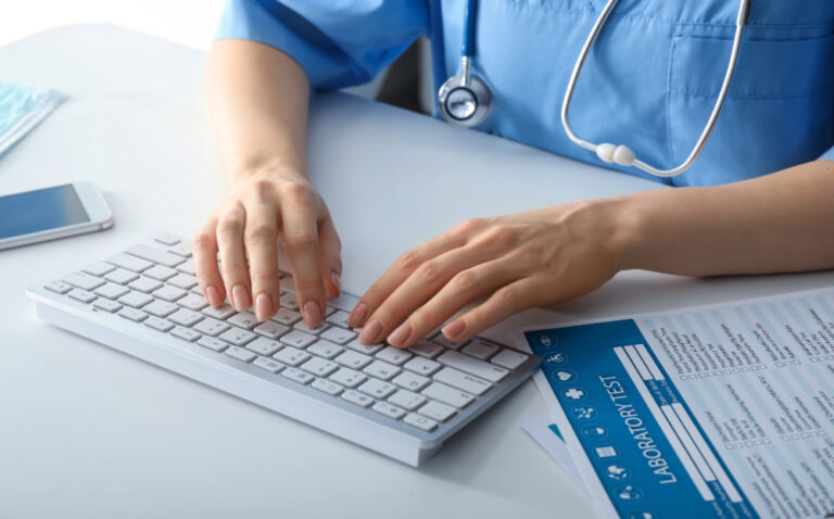 nurse typing on a keyboard