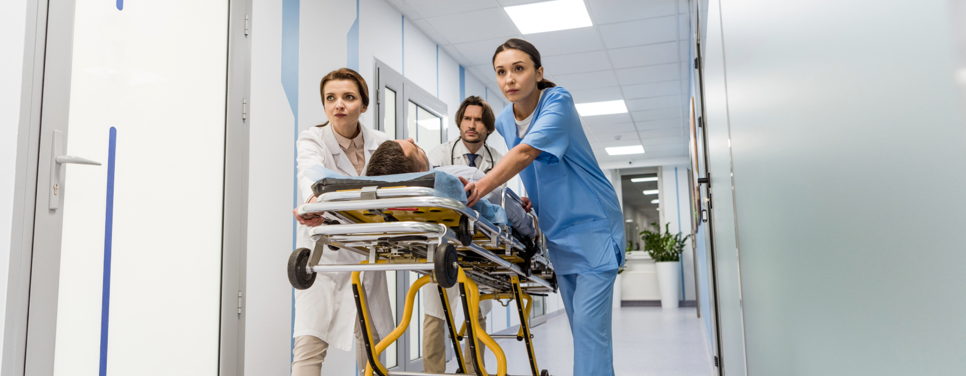 nursing staff pushing patient on a gurney