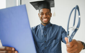 nursing student graduate holding a diploma and a stethoscope