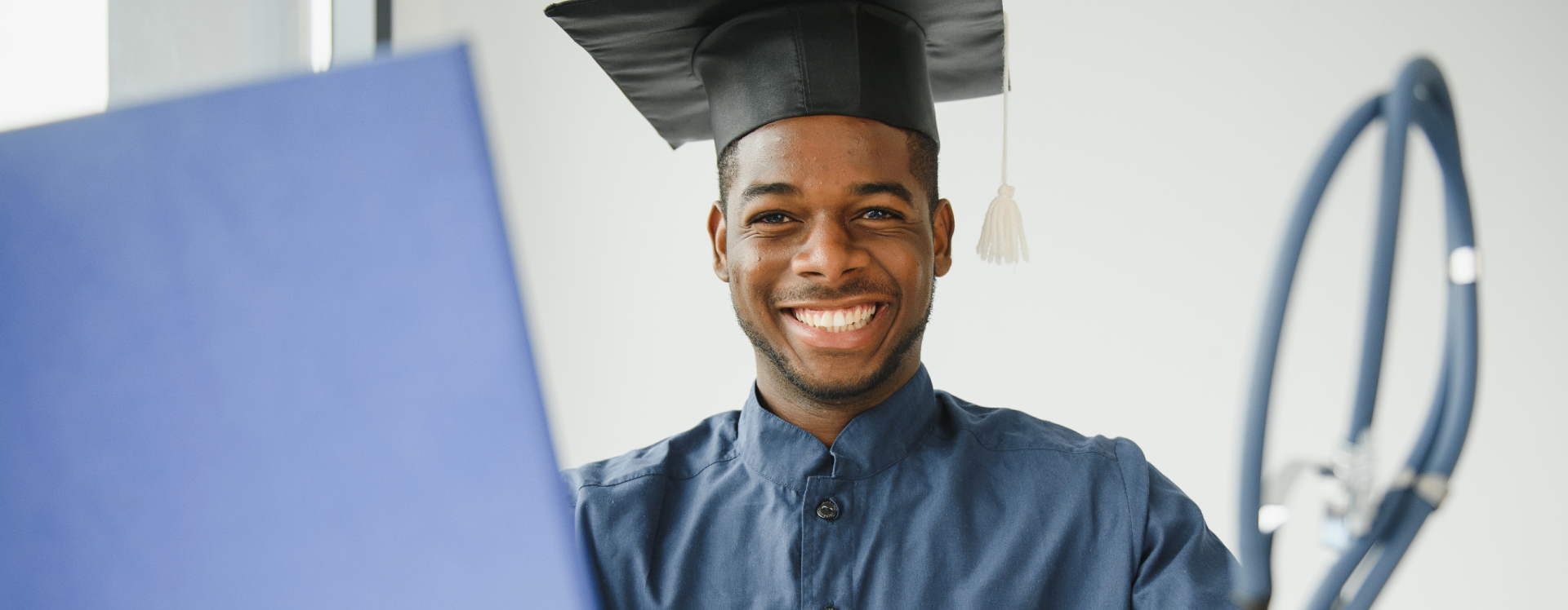 nursing student holding diploma and stethoscope