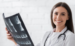 female radiologic technologist holding an x-ray