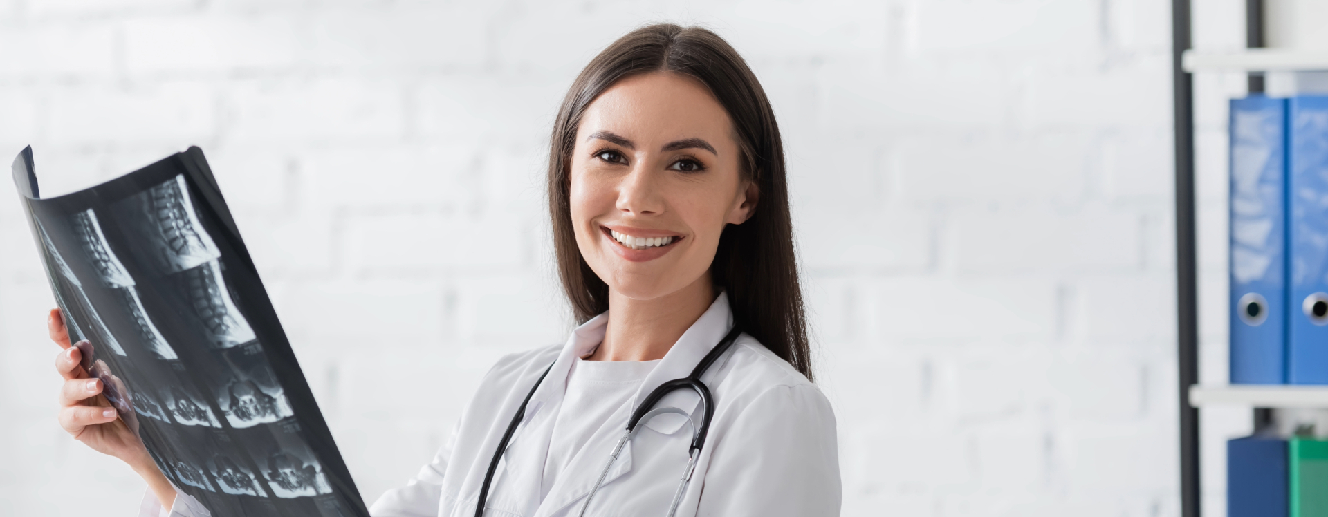 female radiologic technologist holding an x-ray