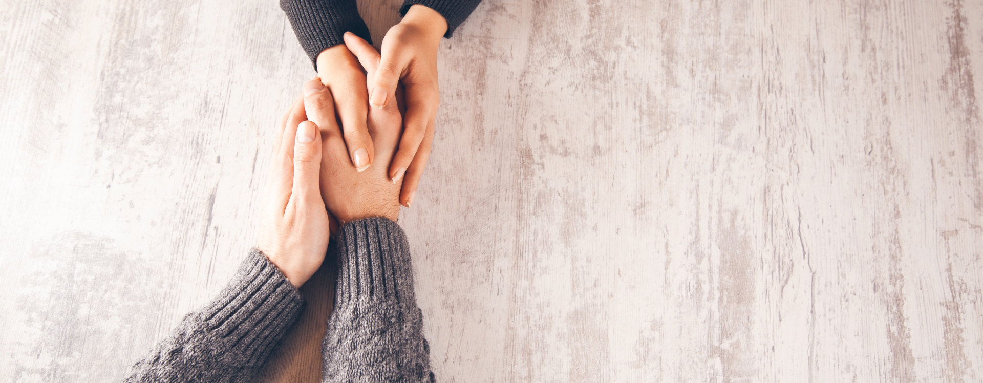 two people holding hands in a counseling session