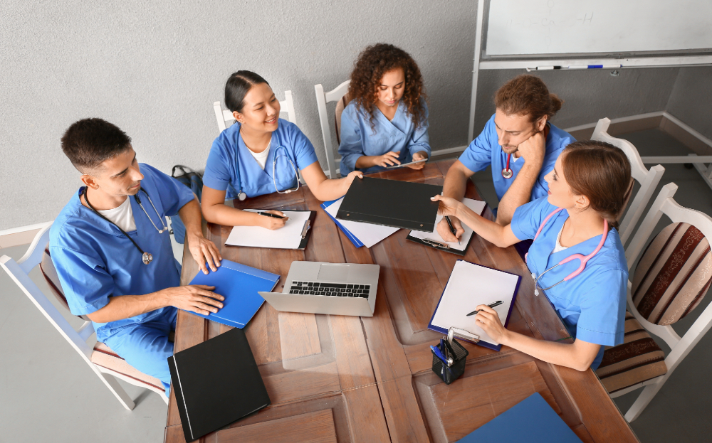 group of nursing students studying at a table