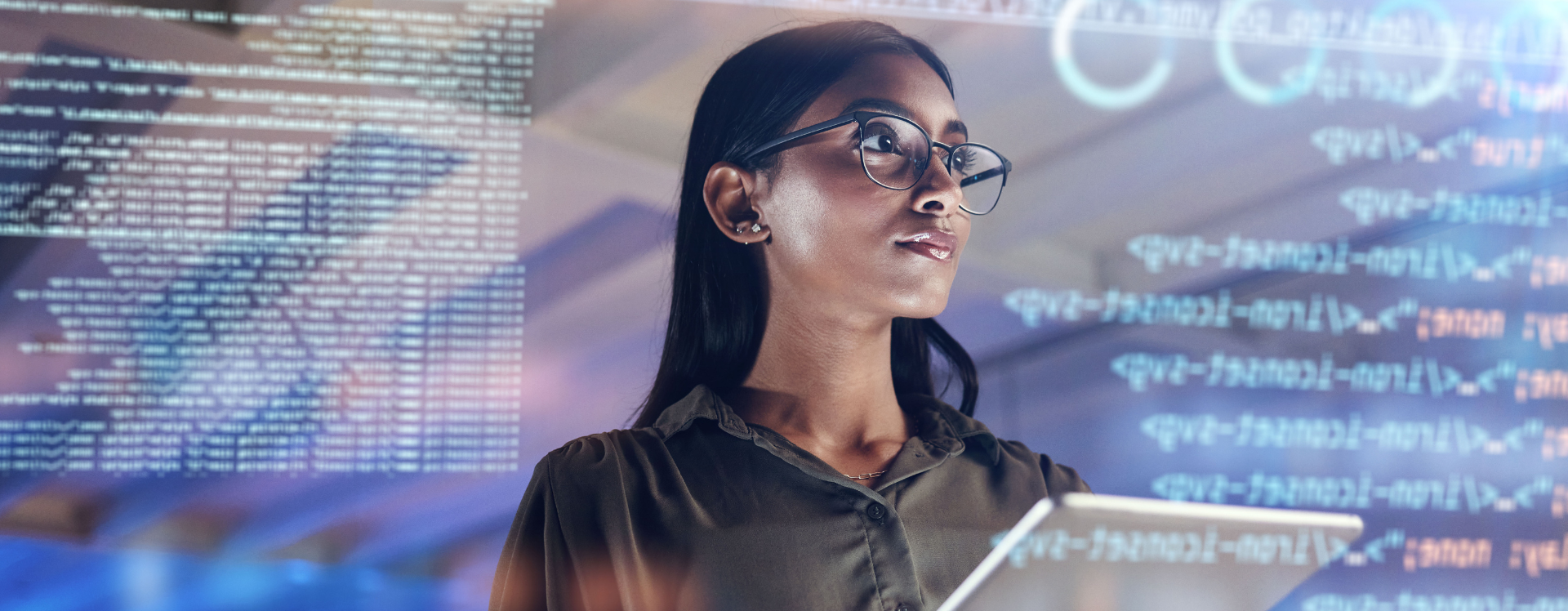 Photo of woman on tablet thinking of data analytics as software coding appears in the foreground