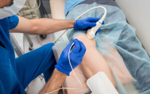 a radiologic technologist scans a patient's leg