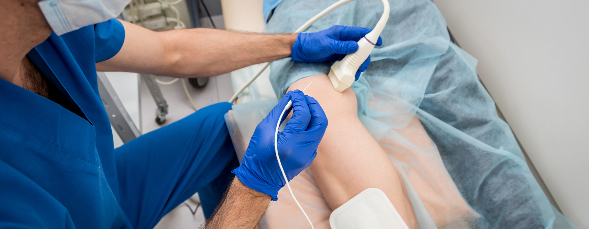 a radiologic technologist scans a patient's leg